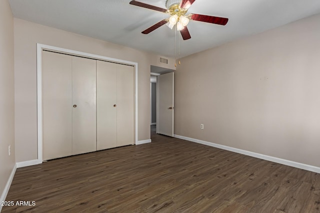 10001 W Caron Dr, Sun City, AZ 85351 - unfurnished bedroom featuring baseboards, wood finished floors, a closet, and ceiling fan