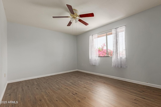 10001 W Caron Dr, Sun City, AZ 85351 - empty room featuring wood finished floors, baseboards, and ceiling fan