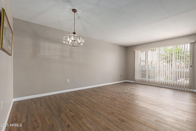 10001 W Caron Dr, Sun City, AZ 85351 - empty room with a chandelier, wood finished floors, and baseboards