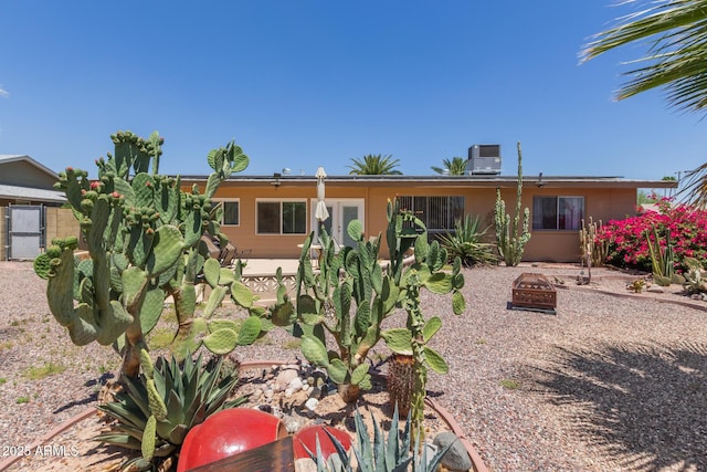 10001 W Caron Dr, Sun City, AZ 85351 - back of house with an outdoor fire pit and central air condition unit