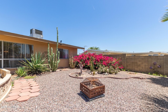 10001 W Caron Dr, Sun City, AZ 85351 - view of yard with an outdoor fire pit and central AC