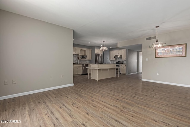 10001 W Caron Dr, Sun City, AZ 85351 - living room featuring a chandelier, wood finished floors, baseboards, and recessed lighting