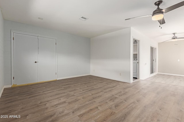 10001 W Caron Dr, Sun City, AZ 85351 - unfurnished room featuring wood finished floors, a ceiling fan, baseboards, and washer / clothes dryer