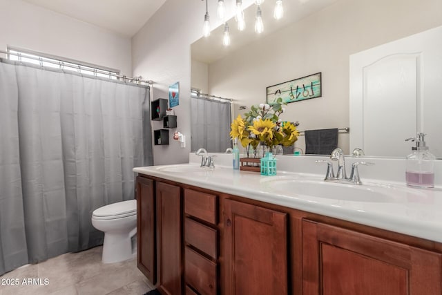 bathroom featuring tile patterned flooring, vanity, and toilet