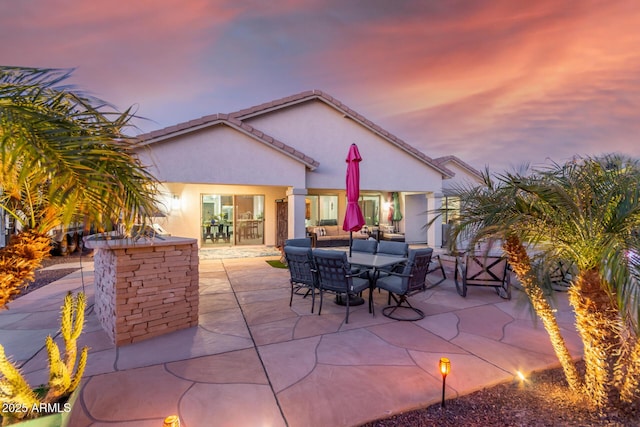 view of patio terrace at dusk