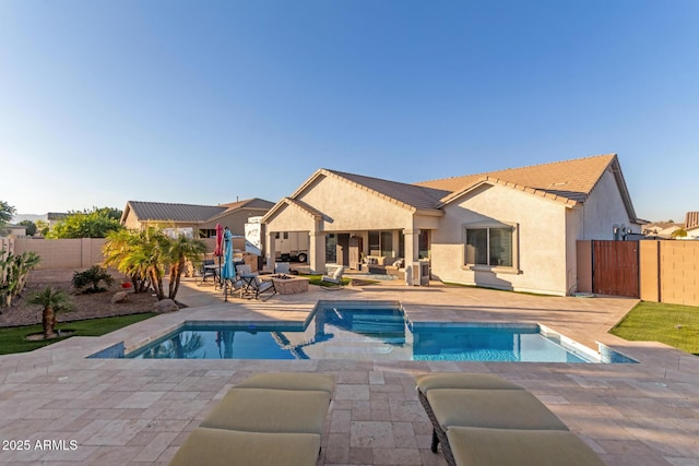 view of pool featuring a jacuzzi and a patio