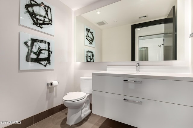 bathroom with tile patterned floors, vanity, and toilet