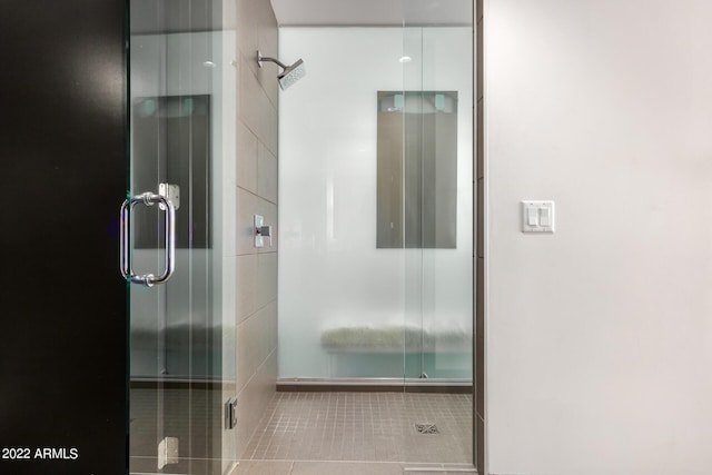 bathroom with tile patterned flooring and an enclosed shower