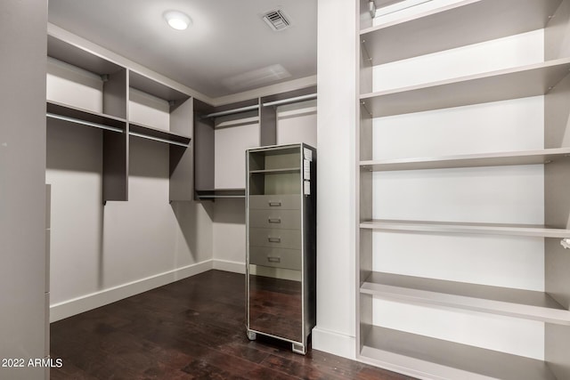 walk in closet featuring dark hardwood / wood-style flooring