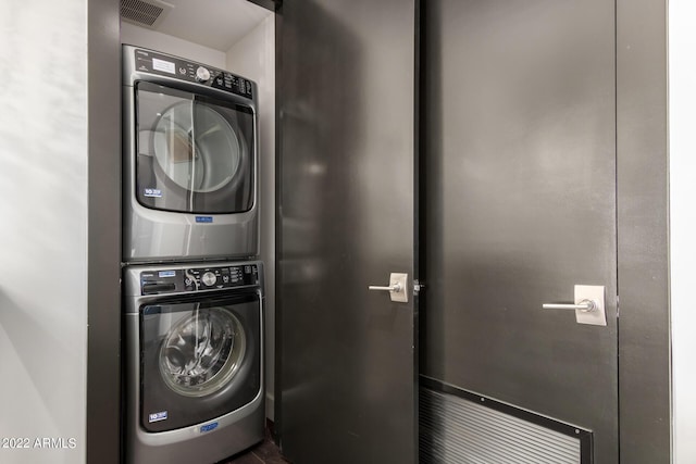 laundry room with stacked washer / drying machine