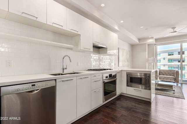 kitchen with decorative backsplash, sink, white cabinets, and stainless steel appliances