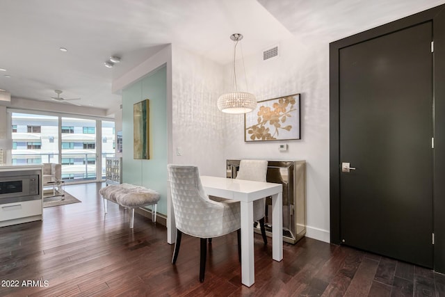 dining room featuring ceiling fan and dark wood-type flooring