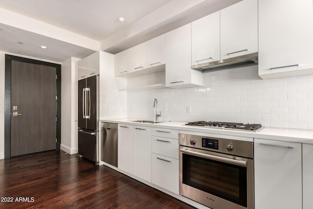 kitchen featuring white cabinets, stainless steel appliances, and tasteful backsplash