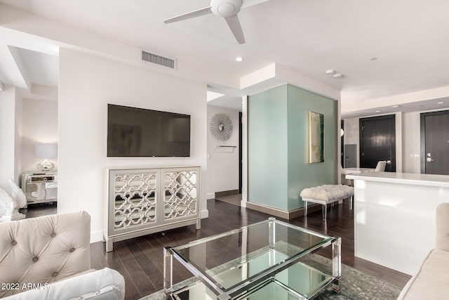 living room featuring ceiling fan and dark hardwood / wood-style flooring