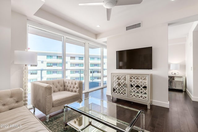 living room featuring ceiling fan and dark wood-type flooring