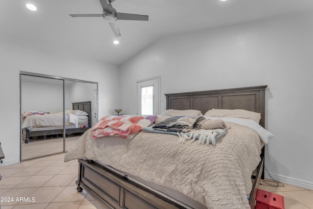 bedroom featuring lofted ceiling, ceiling fan, a closet, and light tile patterned flooring