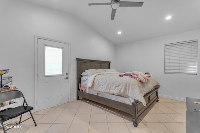 bedroom with vaulted ceiling, light tile patterned floors, and ceiling fan