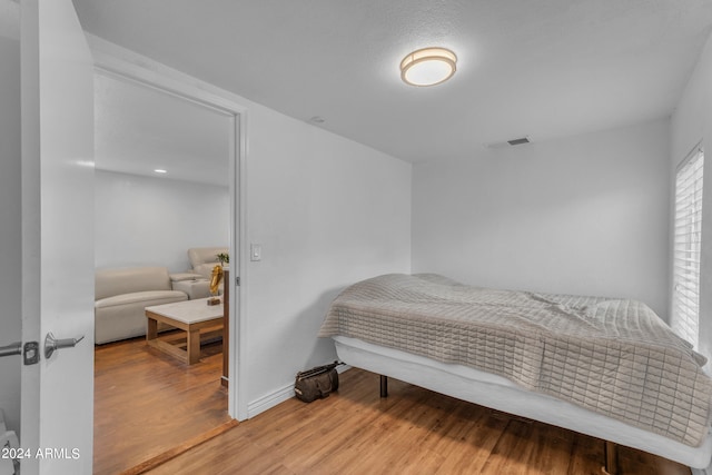 bedroom with wood-type flooring