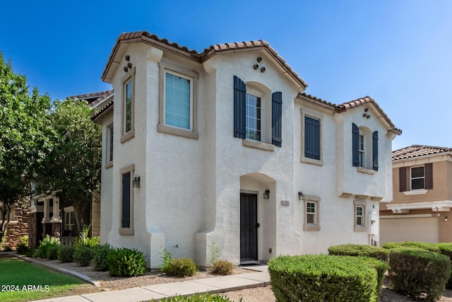 4243 E Jasper Dr, Gilbert, AZ 85296 - mediterranean / spanish-style house featuring a tile roof, stucco siding, and an attached garage