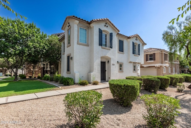 4243 E Jasper Dr, Gilbert, AZ 85296 - mediterranean / spanish-style home featuring a tile roof, stucco siding, and a front yard