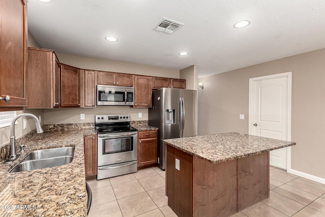 kitchen with a sink, stainless steel appliances, visible vents, and light tile patterned floors