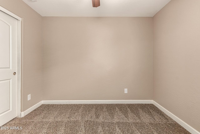 carpeted empty room with baseboards and a ceiling fan