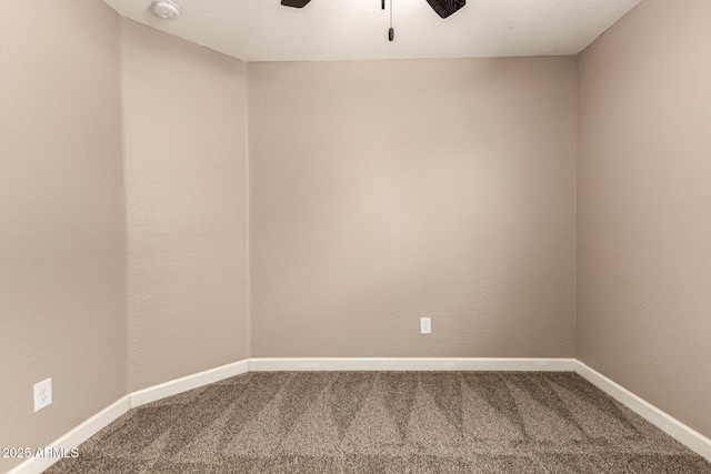 carpeted empty room featuring baseboards and ceiling fan