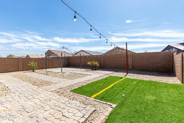 view of yard with a fenced backyard and a patio