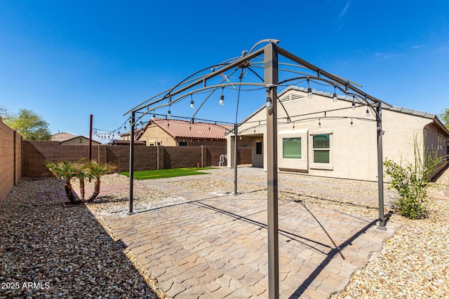 back of house featuring a fenced backyard and a patio area