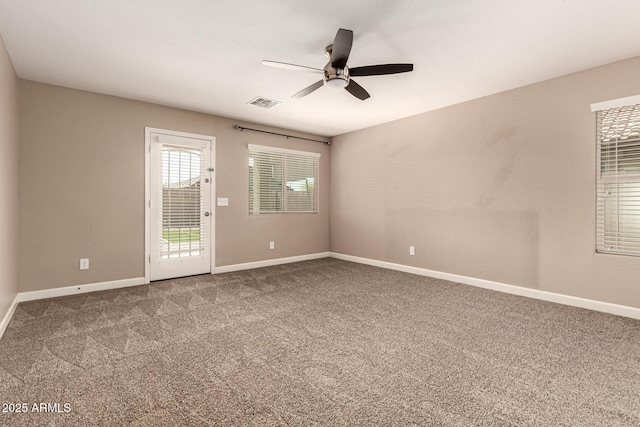 unfurnished room with visible vents, ceiling fan, baseboards, and carpet floors