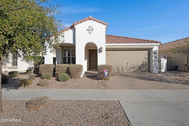 mediterranean / spanish-style home with a garage