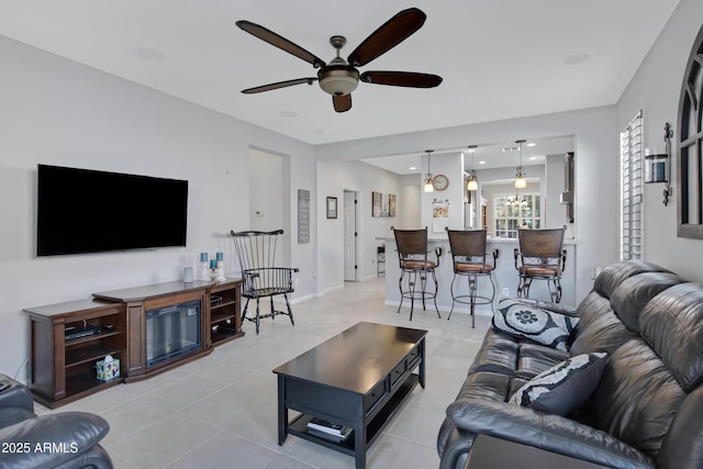 tiled living room featuring ceiling fan