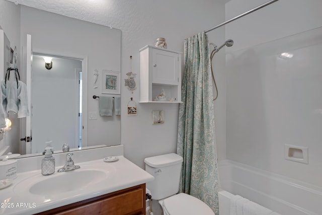 full bathroom with vanity, shower / bath combo with shower curtain, and toilet