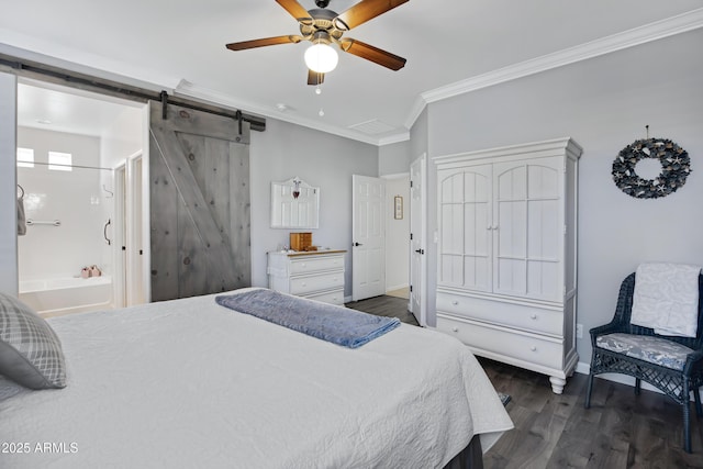 bedroom featuring ensuite bathroom, ornamental molding, dark hardwood / wood-style floors, ceiling fan, and a barn door