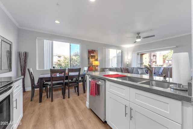 kitchen with sink, a wealth of natural light, stainless steel appliances, and white cabinets