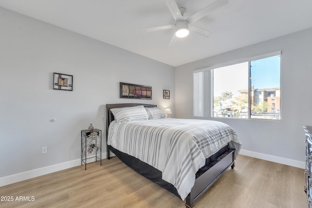 bedroom with light hardwood / wood-style flooring and ceiling fan