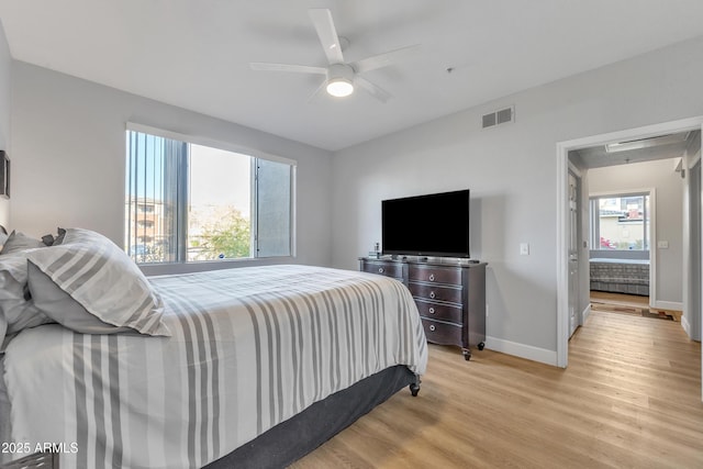 bedroom with ceiling fan and light wood-type flooring