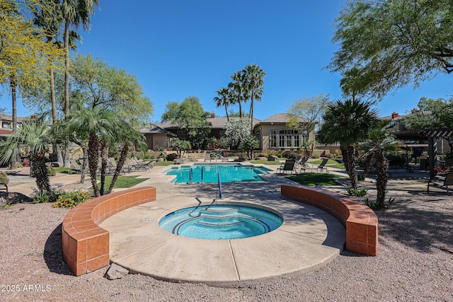 view of swimming pool with a hot tub and a patio