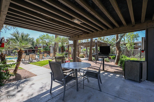 view of patio featuring a community pool and a pergola