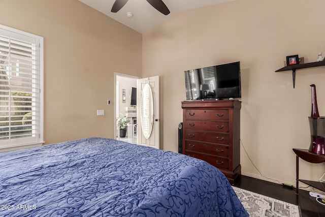 bedroom featuring wood finished floors, vaulted ceiling, and ceiling fan