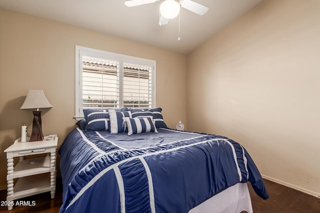 bedroom with ceiling fan, baseboards, and wood finished floors