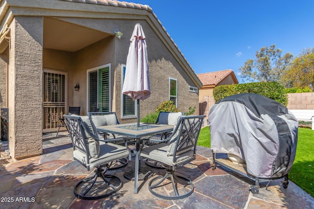 view of patio with outdoor dining area and area for grilling