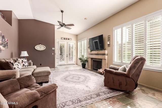 living room featuring baseboards, lofted ceiling, ceiling fan, a premium fireplace, and french doors