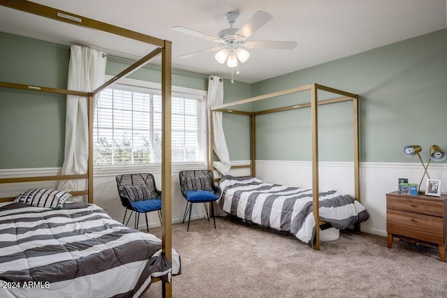 bedroom with ceiling fan and light carpet