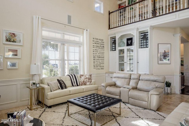 tiled living room featuring a high ceiling