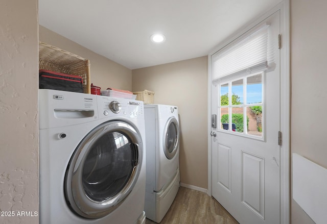 laundry area featuring laundry area, wood finished floors, baseboards, separate washer and dryer, and recessed lighting