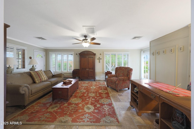 living room with visible vents, plenty of natural light, and stone tile flooring