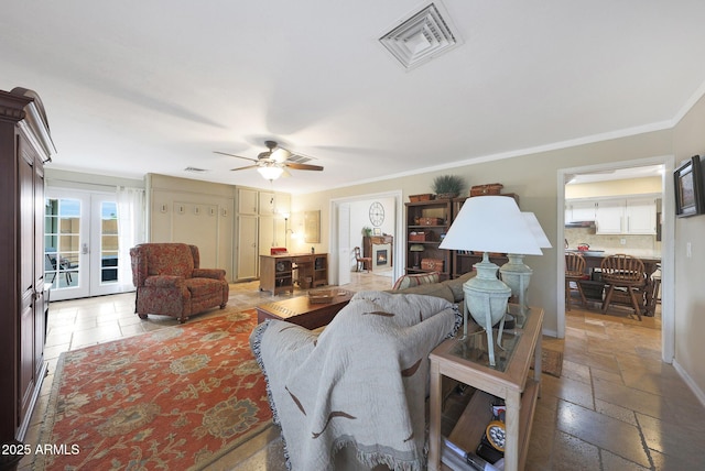 living room featuring ceiling fan, french doors, visible vents, ornamental molding, and stone tile floors