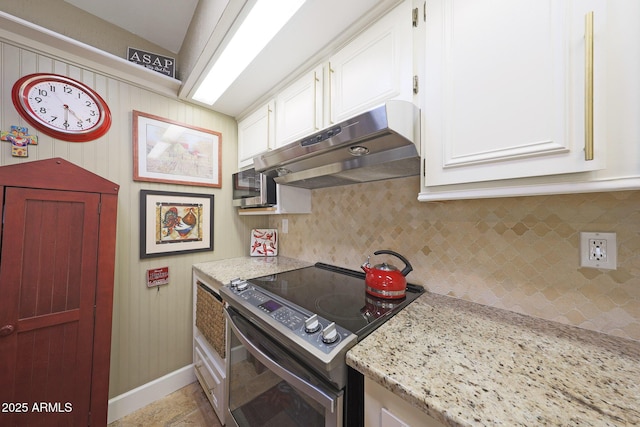 kitchen featuring light stone countertops, range with electric stovetop, white cabinetry, under cabinet range hood, and tasteful backsplash
