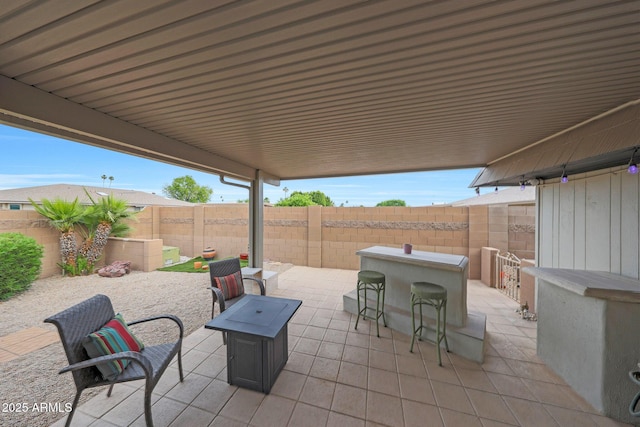 view of patio / terrace with a fenced backyard and outdoor dry bar